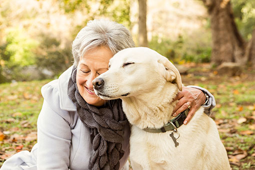 Lady hugging her dog